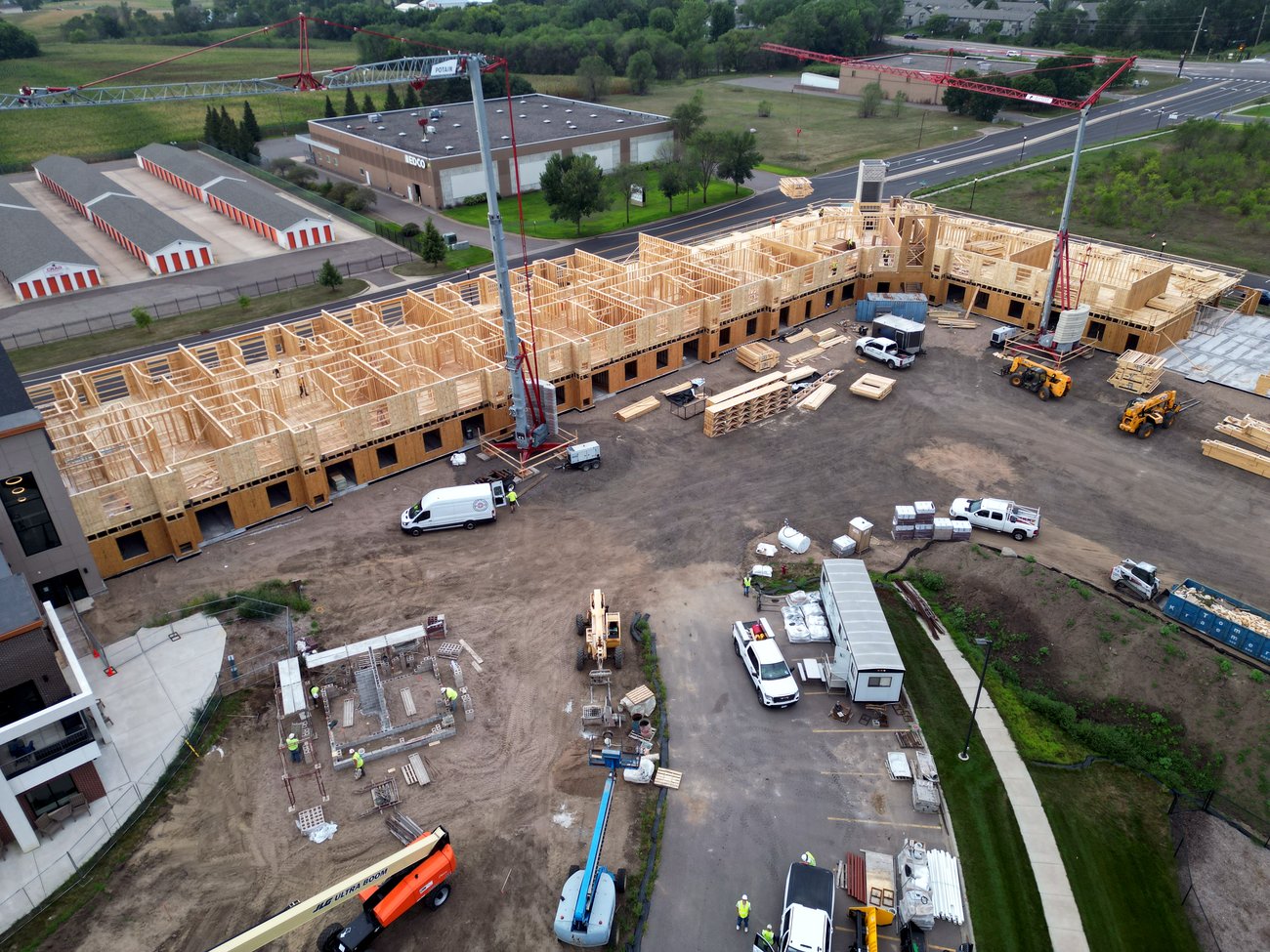 Apartment complex framing with a crane on site