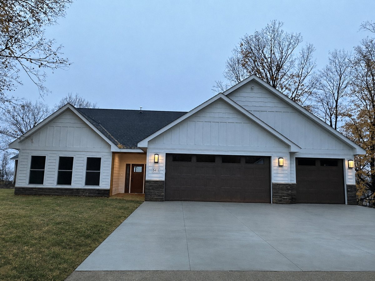 White craftsman custom home with a finished driveway